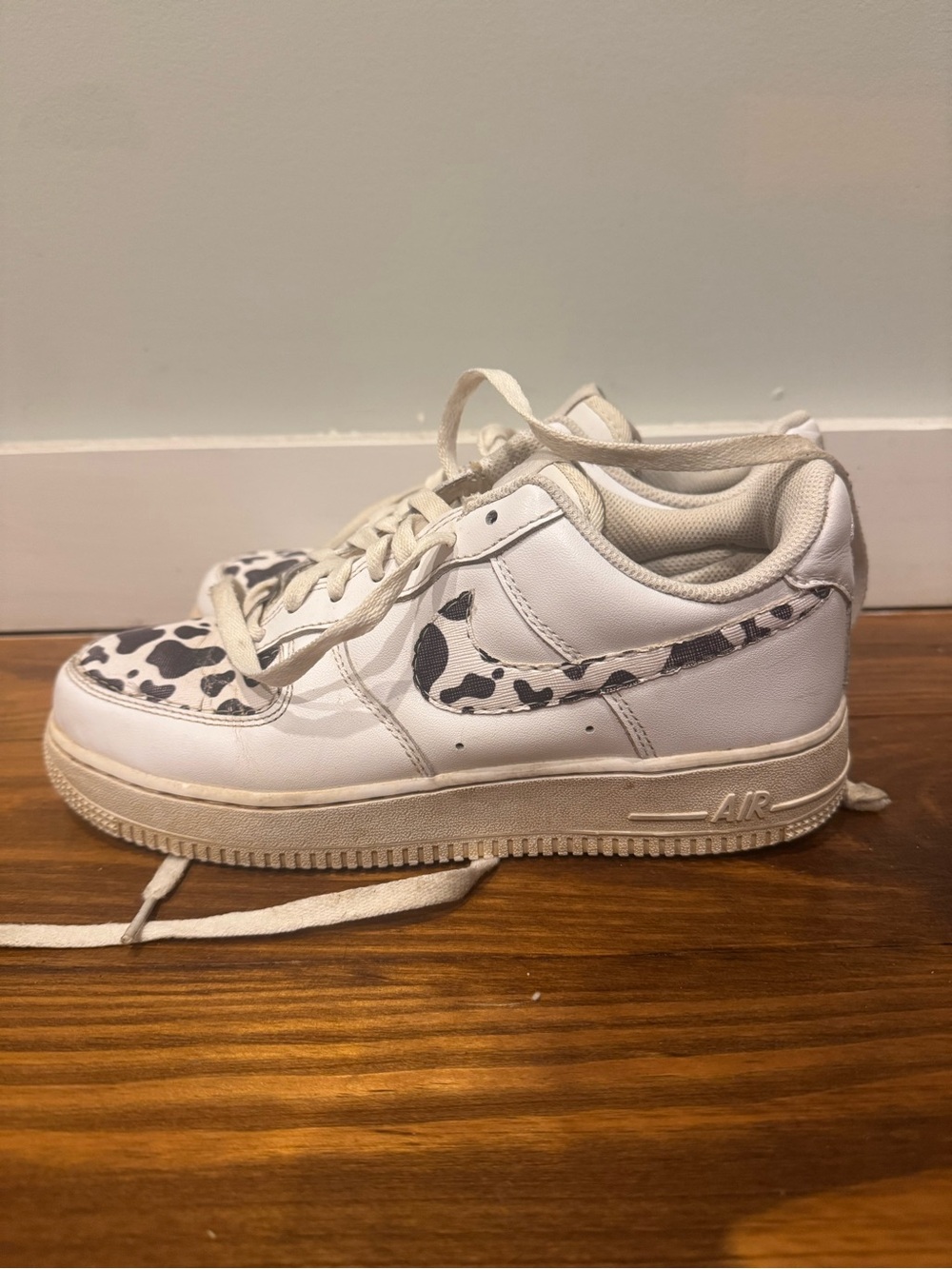 Nike White Low-Top Sneakers with Black Cow Print Swoosh
